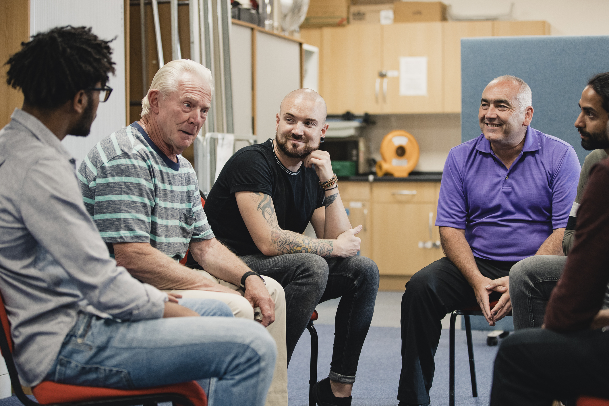 men of all ages in a group talking