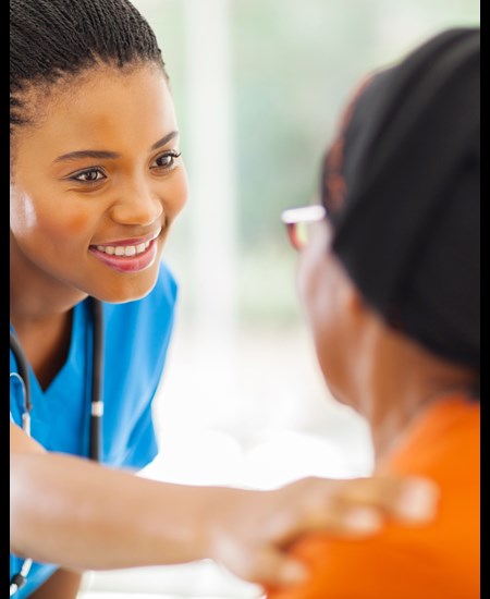 Nurse with hand on patient's shoulder
