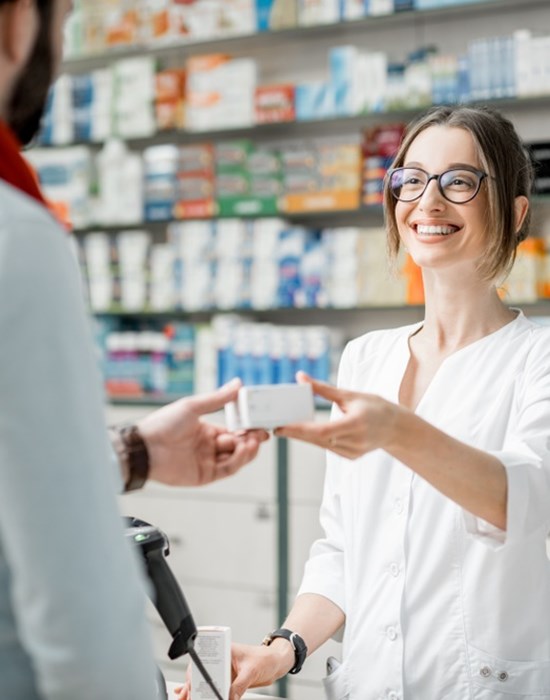 Pharmacist giving man his prescription