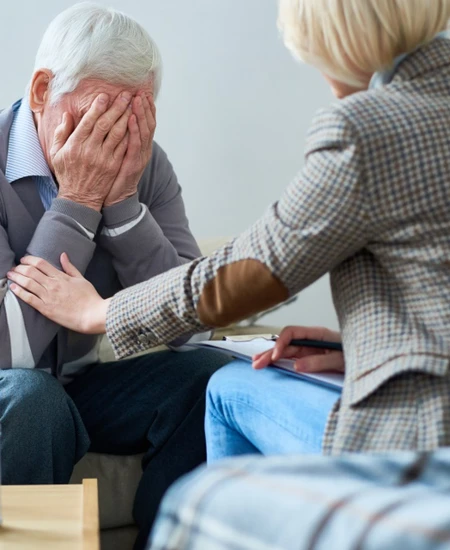 Counselor consoling patient in office.