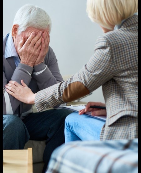 Counselor consoling patient in office.