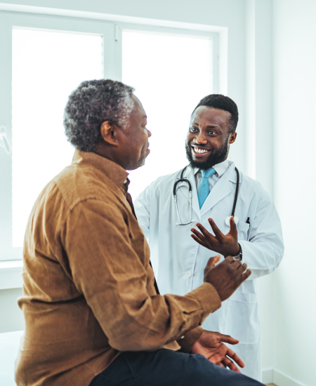 Senior male patient talks with healthcare professional