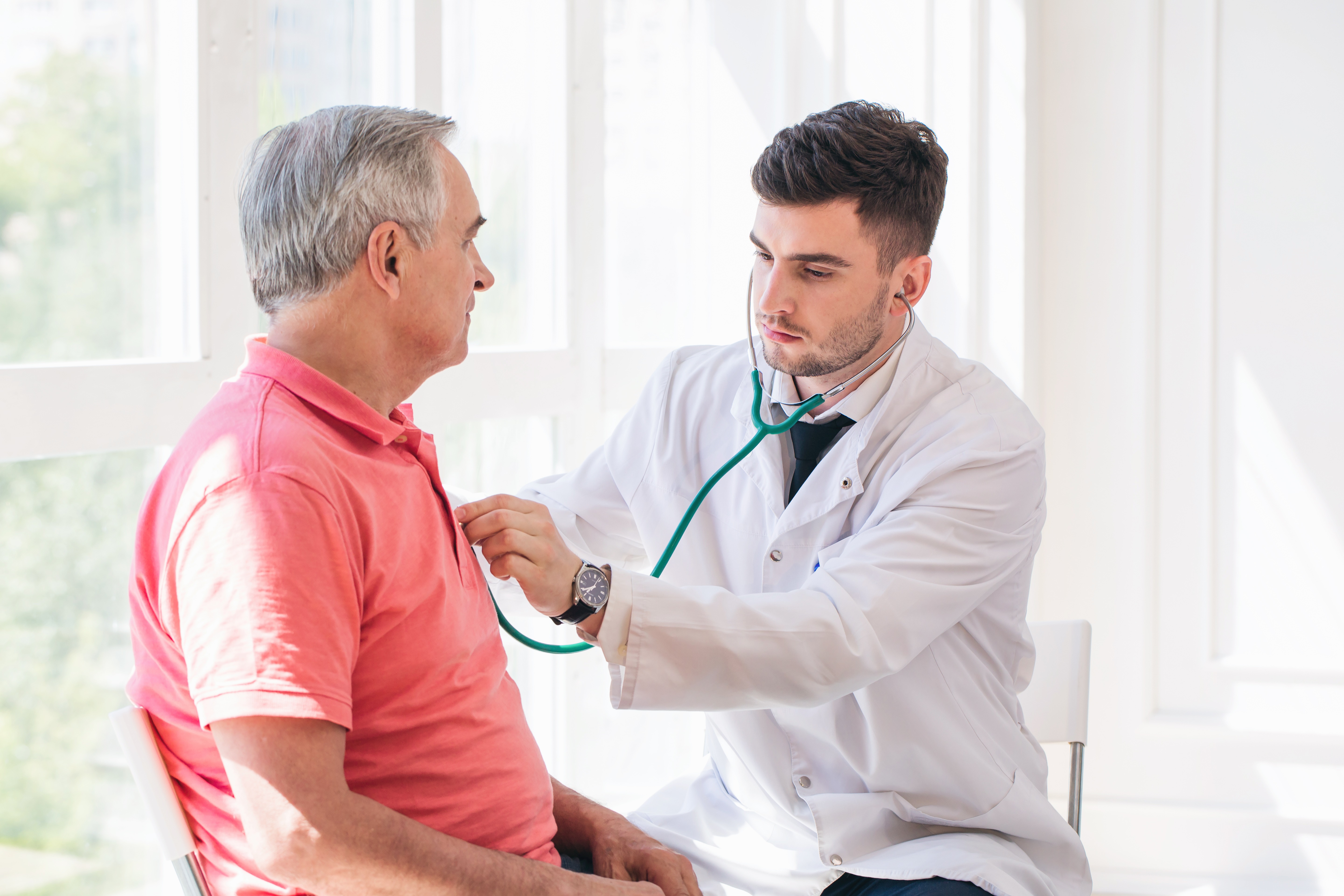 doctor checking heart rate of patient